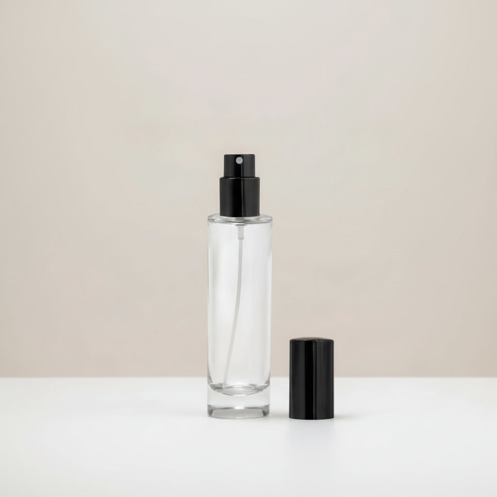 Clear glass bottle with black spray nozzle on a light BHAGAVA 1024*1024
background